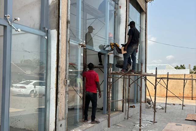 Glorious Fabrication installers fitting large glass panels on site